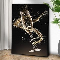 a glass of champagne is being poured into the water on a black and white background