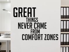 there is a wall sticker that says great things never came from comfort zones on it