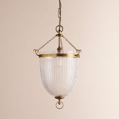 an old fashioned light fixture hanging from a chain