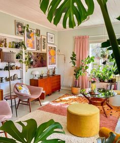 a living room filled with furniture and lots of plants