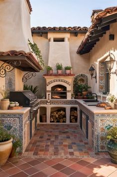 an outdoor kitchen with tile flooring and potted plants