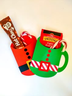 a cup filled with candy and other items sitting on top of a table