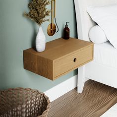 a wooden table with two vases on it next to a bed and wicker basket