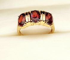 3 stone genuine almandine garnet ring in a 14k gold setting. 3.27 grams ttw. Gorgeous! 14k Yellow Gold Three-stone Ruby Ring, Orange Multi-stone Ring, Yellow Gold Garnet Multi-stone Ring, Red Garnet Multi-stone Rings, Luxury Multi-stone Ruby Ring In 14k Gold, Almandine Garnet, Garnet Ring, Garnet Rings, Ring Set