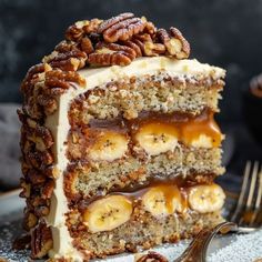 a slice of cake with bananas and pecans on top