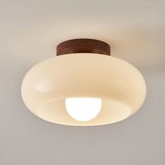 a close up of a light fixture on a ceiling with a white wall in the background