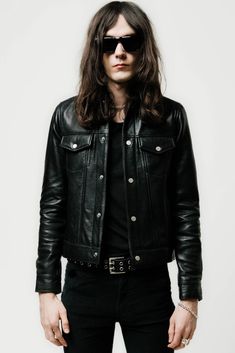 THE LEATHER TRUCKER JACKET IS INSPIRED BY THE ORIGINAL TYPE II TRUCKER JACKET AND EMBRACES THE REBELLIOUS ATTITUDE CULTIVATED BY ITS PREDECESSOR.   ITS CUT IN OUR PERFECTED FIT & AVAILABLE IN A RETRO CROPPED OR A MORE CONTEMPORARY REGULAR LENGTH.   CRAFTED FROM A MEDIUM WEIGHT, FULL GRAIN SHEEPSKIN & FINISHED WITH OUR SIGNATURE RAW METAL HARDWARE Black Leather Short, Leather Trucker Jacket, Outdoor Jackets, Mens Outdoor Jackets, Black Leather Shorts, Leather Shorts, Trucker Jacket, Metal Hardware, Metal Buttons