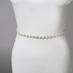 Embroidered pearl and rhinestone sash. Best Seller! Measurements: Embroidery length 30"Height: 1"Ribbon length 80" Elegant White Belt With Rhinestones, Elegant Beaded Silver Sashes, Elegant White Sashes With Rhinestones, Elegant Silver Beaded Sash, Formal Fitted Sash With Rhinestones, Elegant Beaded Bridal Belt, Elegant Beaded Fitted Bridal Belt, White Embellished Fitted Sash, Elegant Embellished Fitted Sash