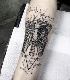 a person with a tattoo on their arm that has a drawing of a human torso