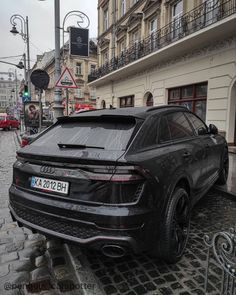 a black car parked on the side of a street