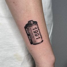 a person with a can tattoo on their arm