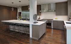 a kitchen with wooden floors and white counter tops