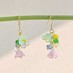 🍀 Size: 4.7 x 2.2 cm 🍀 Material: 14K Gold Plated Sterling Silver Hook, Brass, Glass (✨Hypoallergenic Hook✨) Description 🌸 Introducing our whimsical Cottagecore Rainbow Flower Earrings, a delightful accessory that captures the essence of nature and adds a touch of color and charm to your look. These earrings feature translucent lily of the valley flowers in vibrant rainbow hues, creating a captivating and unique design that embodies the spirit of cottagecore and Y2K fashion. 🌸 ⭐️ Shop more styles at https://etsy.com/uk/shop/StrawberryAtoll. ⭐️ * Shipping *  🇬🇧 Free shipping for UK orders. All our items will be shipped within 1-2 days.  * Packaging & Gift Wrap * 🎀 All our products are packaged with care and attention to detail. To make your purchase even more special, we offer an opti Multicolor Dangle Earrings In Kawaii Style, Kawaii Multicolor Dangle Earrings, Kawaii Dangle Earrings With Ear Wire, Whimsical Dangle Earrings With Flower Charm, Kawaii Drop Earrings, Cottagecore Accessories, Whimsical Cottagecore, Earrings Cottagecore, Earrings Y2k