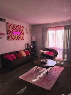 a living room with two couches and a coffee table in front of a window