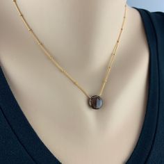 "Smoky Quartz Pendant Simple Necklace Minimalist Necklace Necklace for Women Gemstone Necklace Layering Necklace Dainty Necklace Gift for Her Appearing to float, the bold brownish grey Smoky Quartz balances perfectly on this delicate Satellite Chain. We have threaded the chain through the stone for extra drama. The chain is finished with delicate Smoky Quartz Rondels at the closure and end of the two inch extension. Our Smoky Quartz Pendant is a perfect day to night piece that needs little intro Modern Natural Stone Necklaces For Gifts, Modern Necklaces With Natural Stones For Gifts, Modern Necklaces With Natural Stones, Minimalist Oval Pendant Necklace As Gift For Her, Minimalist Jewelry With Natural Stone Round Pendant, Everyday Gold Charm Necklaces With Natural Stones, Minimalist Jewelry With Natural Stones In Round Pendant, Minimalist Gemstone Pendant Crystal Necklace, Minimalist Jewelry With Round Pendant And Natural Stones