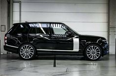 a black and white range rover parked in a garage