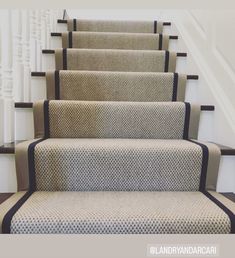 a set of carpeted stairs leading up to the second floor