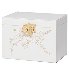 a white box with a gold flower on the front and side, sitting on a white surface