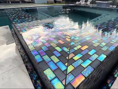 a swimming pool with colorful tiles on it