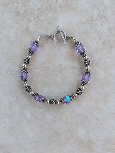 "Sterling Silver 925 and Swarovski Crystal Handmade Bracelet, 7.25\" all beads are sterling silver and Bali sterling silver including toggle clasp. Swarovski crystals are lilac AB 8mm  Any of my handmade jewelry can be adjusted in size, just message me under the listing. Check out my other jewelry at https://loveofjewelryshop.etsy.com" Sterling Silver Beaded Bracelets With Silver Clasp, Sterling Silver Bracelet With Faceted Round Beads, Silver Sterling Bracelets With Faceted Beads, Sterling Silver Crystal Bracelet With Round Beads, Silver Sterling Silver Bracelet With Faceted Beads, Sterling Silver Bracelets With Faceted Beads, Silver Round Beads Crystal Bracelet For Anniversary, Classic Sterling Silver Crystal Bracelet As Gift, Silver Crystal Bracelet With Round Beads For Anniversary