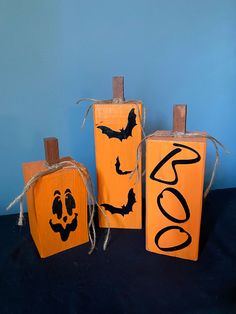 three pumpkin boxes decorated to look like jack - o'- lanternes with bats on them