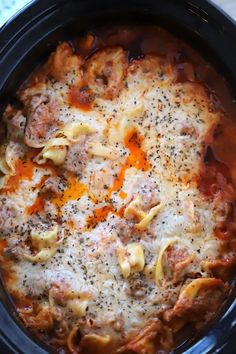 a crock pot filled with pasta and sauce