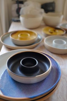 plates and bowls are arranged on a table