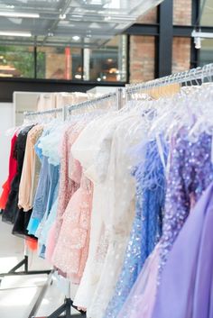 Homecoming dresses showcased on a clothing rack.