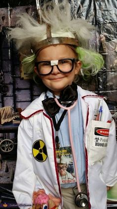 a young boy dressed up as a doctor with green hair and eyeglasses on