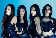 four beautiful young women in black leather outfits posing for the camera with their hands on their hips