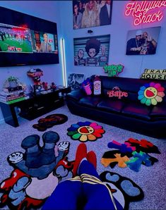 a person laying on the floor in front of a couch with mickey mouse rugs