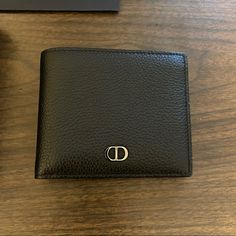 Like New Christian Dior Bifold Wallet, With Black Grained Calfskin And Cd Icon Signature (Finished In Ruthenium Brass). Has Interior Dior Embossing, Snap Button Compartment For Coins, Double Bill Holder Pockets, Two Flat Compartments And Four Card Slots. Includes Original Box And Purchase Bag. Dimensions: 4.5in X 4in. High-end Leather Wallet For Formal Occasions, Designer Black Wallets With Leather Lining, Designer Wallets With Leather Lining For Formal Occasions, High-end Leather Wallet For Formal Use, High-end Leather Wallets For Formal Occasions, Classic Leather Wallet For Everyday Luxury, Designer Leather Wallet, Cd Icon, Bill Holder