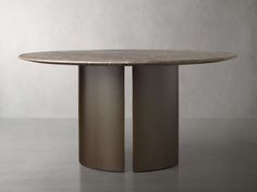 a round marble dining table with two metal pedestals