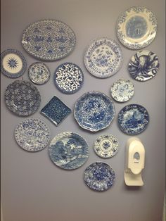 a collection of blue and white plates on a wall