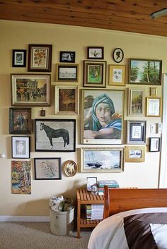 a bedroom with many pictures on the wall