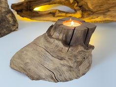 a candle that is sitting on top of a piece of wood