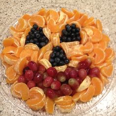 an assortment of fruits arranged in the shape of a face