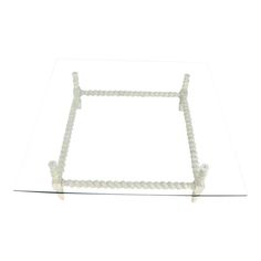 a glass table with white beads on it