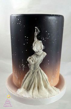 the cake is decorated with an image of a woman in a white dress on it