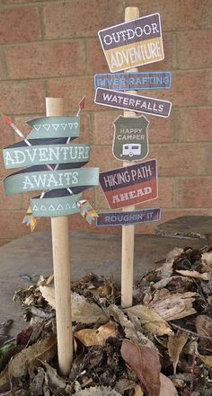 there are many signs on top of the leaves in front of a brick wall that says outdoor adventure waterparks and hiking path