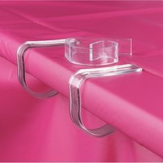 a close up of a pink curtain with a glass holder on the top of it