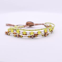 This multi layer bracelet is adjustable and has a second loop allowing some extra length.  Size: Adjustable from ~6.5-7in         >First Loop at ~6.5inches         >Second Loop at ~7inches Beads: Glass Beads/ 11/0 Seed Beads         >Green/White/Bronze/Brown Clasp:  Coconut Button          >Brown Cord: Nylon Cord         >Brown *Photos are taken with care to ensure the color is portrayed correctly. However, due to different screen resolution, screen brightness, lighting, etc... from phone screens to computer screens, colors in the bracelet may differ slightly than pictured. If you have any questions, please don't hesitate to message me. Adjustable Beaded Multi-strand Friendship Bracelets, Adjustable Multi-strand Colorful Beads Wrap Bracelet, Adjustable Brown Multi-strand Wrap Bracelet, Adjustable White Beaded Bracelets As Fashion Accessory, Trendy Adjustable White Wrap Bracelet, Adjustable Beaded White Wrap Bracelet, Adjustable White Beaded Wrap Bracelet, Phone Screens, Layered Bracelets