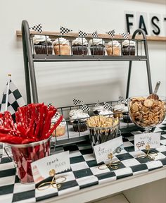 an assortment of desserts are displayed on a checkered tablecloth at the breakfast buffet