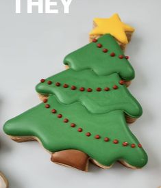 there is a decorated christmas tree cookie on the table