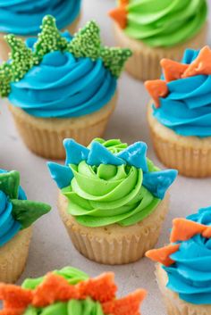 cupcakes decorated with blue, green and orange frosting