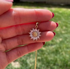 Beautiful Sunflower necklace in your choice of chain length. Diamond-like cubic zirconias make the sunflower charm sparkle. The chain and other components are 14k Gold Filled. Sunflowers are a symbol of loyalty, making them a great gift! Similar style bracelet can be found here - https://www.etsy.com/ca/listing/990937785   Details: Sunflower charm measures at 18mm Surgical steel base metal with non-tarnishing gold finish and cubic zirconia crystals The chain and other components are 14k Gold Fil Gold Flower Necklace With Cubic Zirconia, Gold Flower-shaped Cubic Zirconia Necklaces, Gold Flower-shaped Necklace With Cubic Zirconia, Gold Jewelry With Sparkling Flower Stones, Cubic Zirconia Flower Charm Jewelry For Anniversary, Flower-shaped Jewelry With Sparkling Stones For Gift, Flower Shaped Sparkling Stones Jewelry For Gifts, Cubic Zirconia Flower Pendant Jewelry With Charm, Flower Shaped Jewelry With Sparkling Stones For Gifts