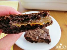 a hand holding a half eaten chocolate cookie