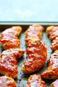 chicken parmesan with marinara sauce on a baking sheet ready to go into the oven