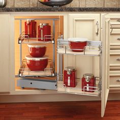 an open cabinet with pots and pans in it