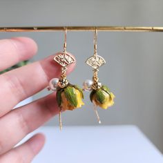 Our yellow rose with Japanese fan earrings are made with oriental style gold plated fan, real yellow rose, manmade pearl, gold plated Asian lantern beads and 14K gold plated earring hooks which are good for delicate ears. Size: approx. 0.75" x 2.5" 🌺All rose flower earrings are gently handmade by me, giving each item unique detail & character. Please understand the roses are natural flowers and there are no two items exactly alike. Gold Dangle Flower Earrings With Rose Design, Elegant Rose Flower Earrings, Elegant Yellow Flower Earrings, Elegant Yellow Dangle Flower Earrings, Elegant Yellow Flower Shaped Earrings, Elegant Rose Red Flower-shaped Earrings, Birthday Earrings, Real Flower Earrings, Wedding Rose